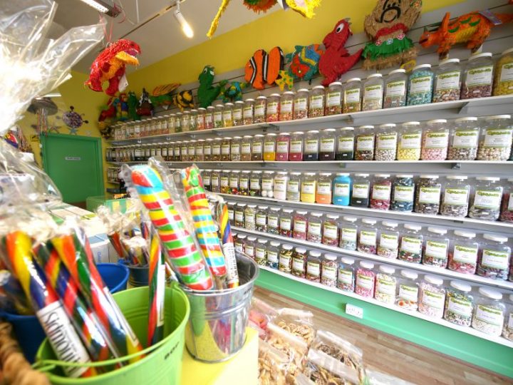 An internal photo of our Devon based sweet shop showing some of our 350 sweet jars and various rocks and pinatas